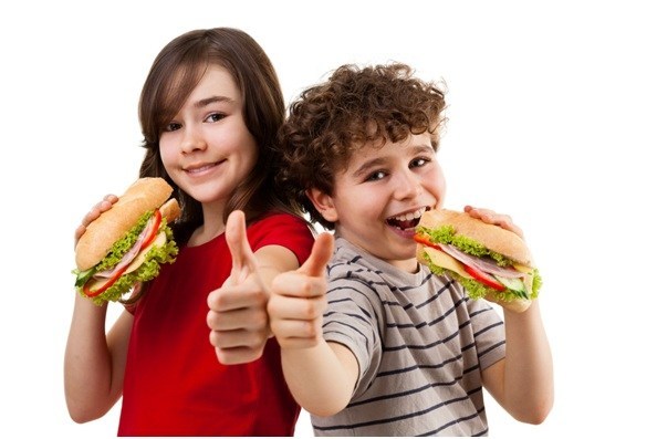 Happy kids eating sandwiches