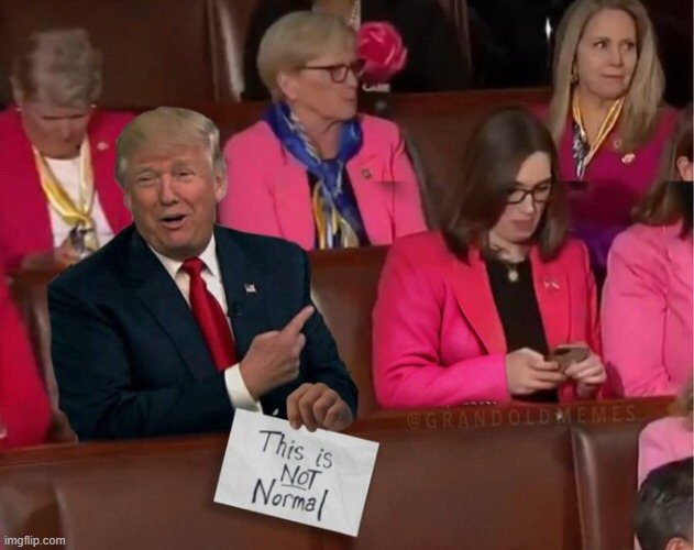 Trump next to trans congresscritter with sign This is not normal
